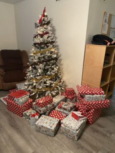 Christmas tree and presents in a corner of a room