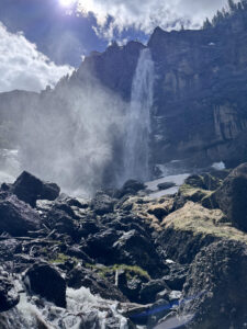 design patent invalidity | Thomas W Galvani, PC Waterfall flowing from a steep cliff into a misty, rocky basin with scattered snow and dark, jagged rocks in the foreground.